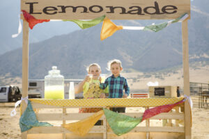 branding: colorful lemonade stand with children